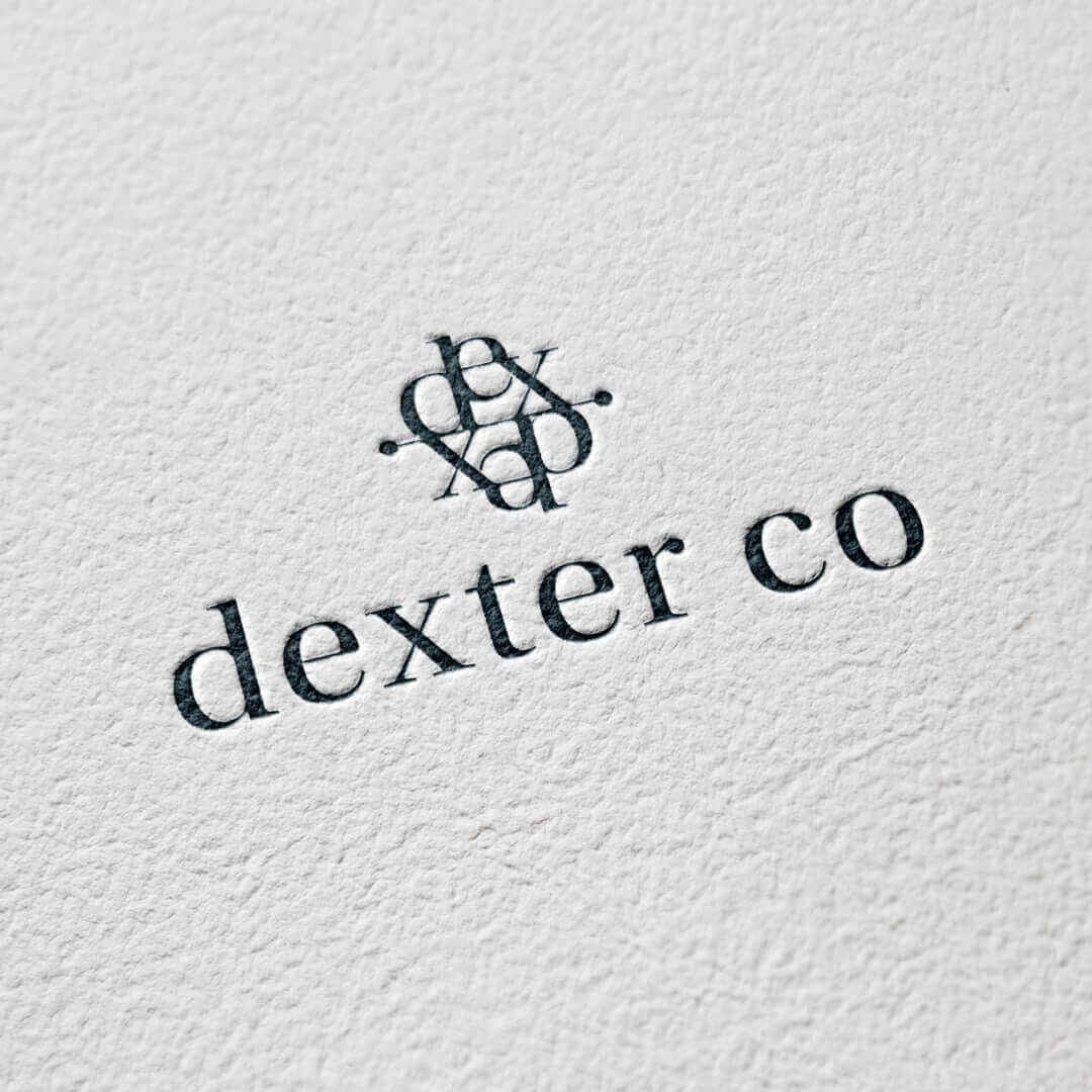 Logo of Dexter Co depicting elegant typography on textured background.