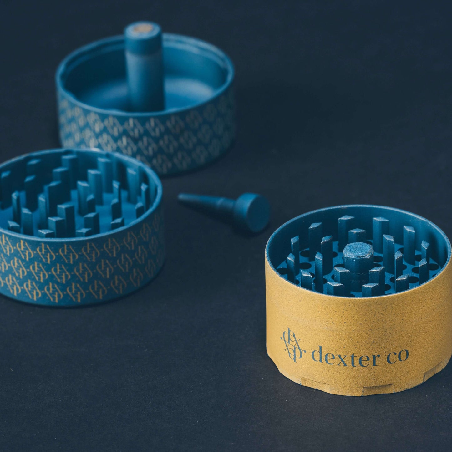 Dexter Grinder in slate blue gray and gold, showcasing innovative design and premium craftsmanship.