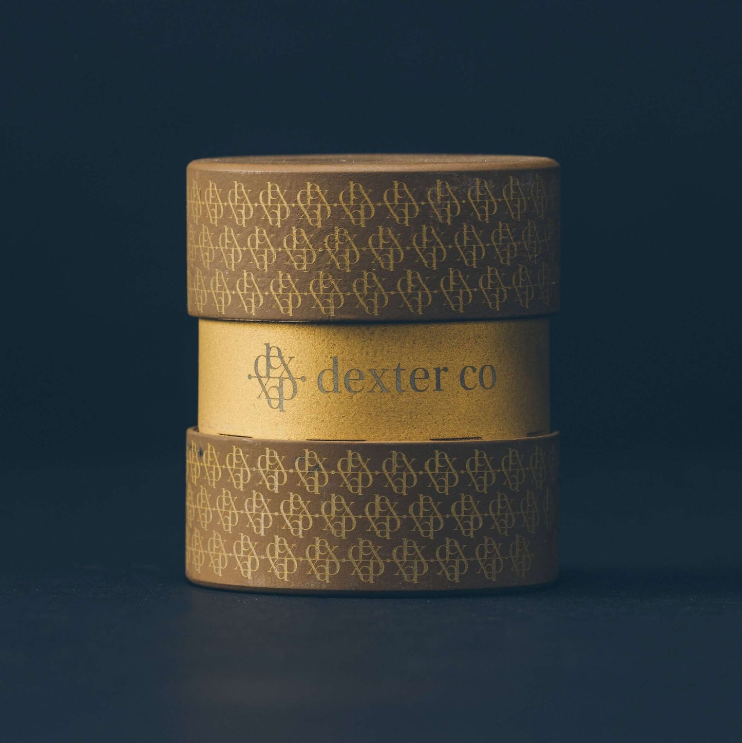 Dexter Grinder in taupe and gold, showcasing sophisticated design and artisan craftsmanship for premium smoking accessories.