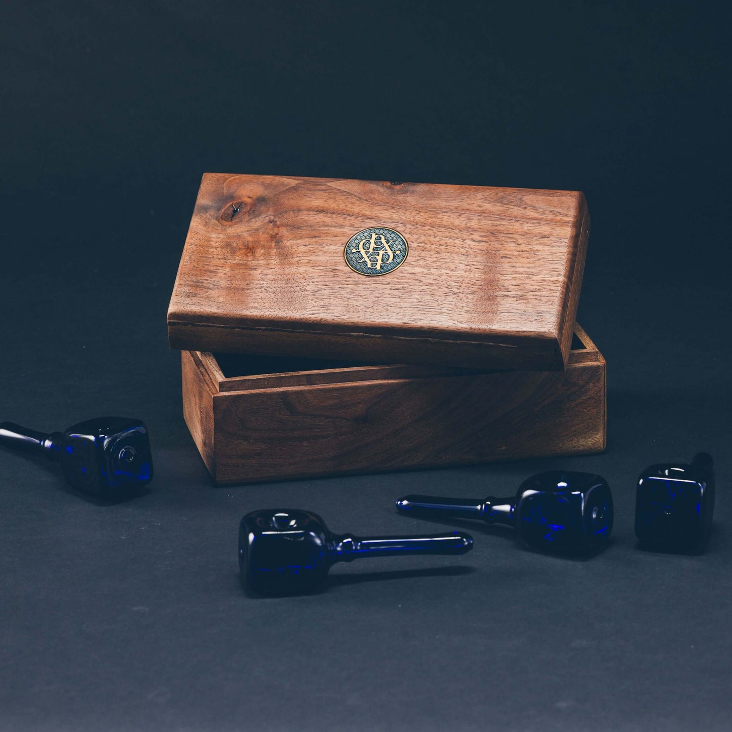 Dexter Pipe Set with four handblown blue pipes displayed next to a handmade dark walnut presentation box.