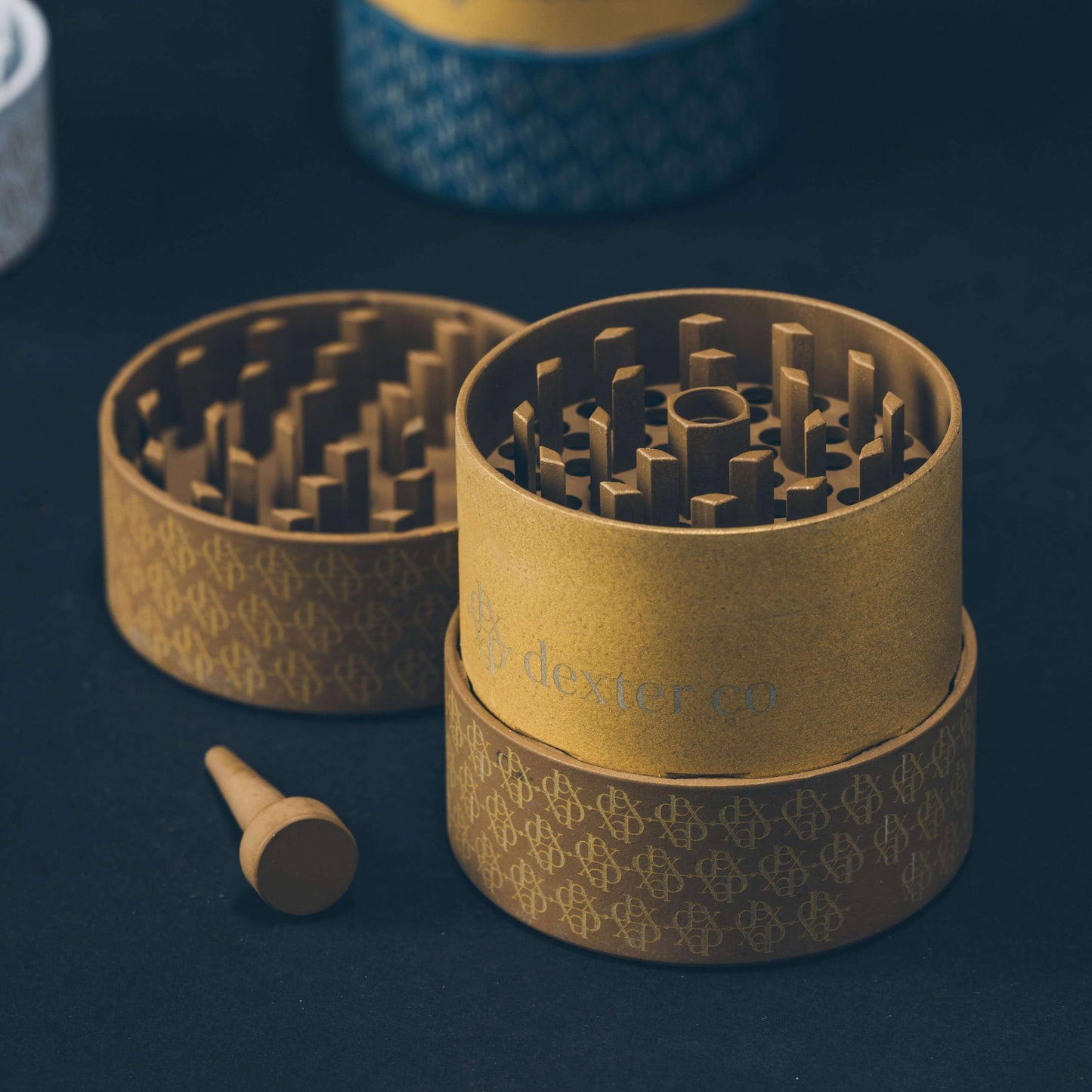 Dexter Grinder in taupe and gold, showcasing artisan craftsmanship and innovative threadless design for premium cannabis.