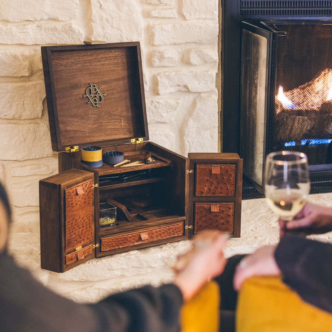 Dexter Co cannabis storage box displayed by fireplace during cozy gathering
