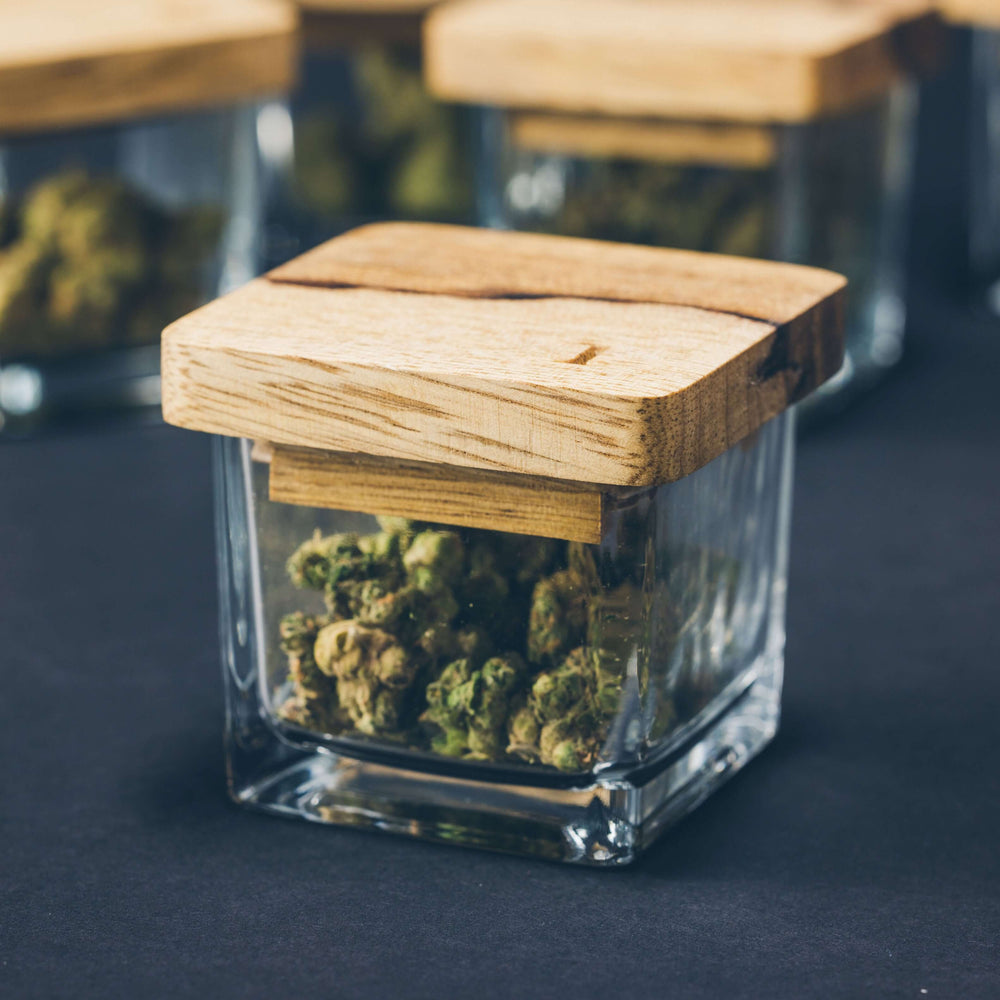 Artisanal strain jar with wooden lid, perfect for luxury flower storage and elegant cannabis accessories.